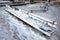Snow-covered wooden benches