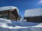 Snow covered wooden cottages in Swiss alps