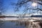 Snow covered wooden jetty at a frozen lake on a sunny day in germany