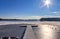 Snow covered wooden jetty at a frozen lake on a sunny day in germany