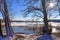 Snow covered wooden jetty at a frozen lake on a sunny day in germany