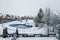 Snow-covered yard with a pool in a beautiful neighborhood in Bucharest. Christmas background. Cold temperature, wintertime