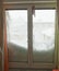 Snow covers half window. Snowfall in Europe