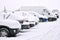 Snow cowered cars on a parking lot