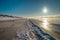 Snow Curonian Spit dunes in January winter sunny day. Blue sky and sea, no people on the beach, calm and beautiful view