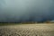 Snow dark front cloud and plowed field