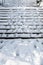 Snow day, snow covered concrete staircase with footprints coming and going