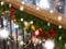 In the snow decorated railing with a green Christmas tree, multi-colored bows and balls.