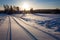 Snow dirt road at countryside sunset