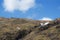 Snow drift at head of steep mountain valley in moorland Lake District