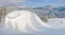 Snow-drift beside of ski piste on background of mountain
