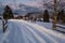 Snow drifts on road through twilight small and quiet winter alpine village, Voronenko, Carpathian, Ukraine. Night countryside