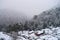 Snow Fall, Misty Valley, Huts, and Trees - Winter in Indian Village in Uttarakhand in Himalaya