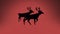 Snow falling over silhouette of two reindeers walking against orange background