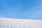 Snow field and blue sky, wintry background