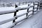 Snow filled horse corral winter time without horses. Shallow depth of field