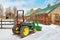 Snow filled Winter tractor and farm barns scenic