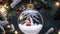Snow globe with Santa Claus and Christmas tree on bokeh background