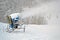 snow gun (pulverizer) disperse artificial snow on high mountain, winter seasonal environment, white hill