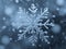 snow ice crystal shape macro snowflake falling on cold winter night christmas blue background