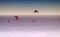 Snow kiters gliding in the sun on snow and ice an awesome feeling