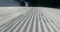 Snow lines made from a snow machine on a ski slope