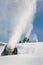 Snow-machine bursting artificial snow over a skiing slope