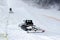 Snow machines on the snow-covered road ski resort.