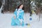 The snow maiden girl walks in the winter forest