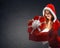 Snow Maiden in red suit smiling holding a gift, opens a gift on