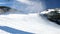 Snow making on slope. Skier near a snow cannon making fresh powder snow. Mountain ski resort in winter calm.