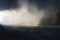 Snow making on slope. Skier near a snow cannon making fresh powder snow. Mountain ski resort in winter calm.