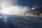 Snow making on slope. Skier near a snow cannon making fresh powder snow. Mountain ski resort in winter calm.