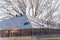 Snow melting on roof shingles of suburban residential house in Coppell, Texas, USA