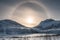 Snow mountain range with sun halo in winter