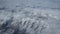 Snow on mountain tops view through plane window. Aerial views in snow mountain in southwest China. Top view