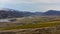 Snow mountains behind the river in Iceland