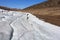 Snow in the mountains melts in the spring. Layers of snow descend in parts from the slope. Natural background