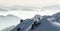 Snow Mountains Panorama in low lying inversion valley fog. Silhouettes of foggy Mountains. Scenic snowy winter landscape