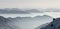 Snow Mountains Panorama in low lying inversion valley fog. Silhouettes of foggy Mountains. Scenic snowy winter landscape