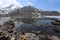 Snow mountains reflected in the calm waters of Gosaikunda lake in Nepal. Stillness, meditative concept image.