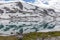 Snow mountains surrounded by clouds in norwegian fiord reflection in water selective focus