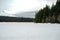 Snow mountains and trees frozen lake
