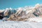 Snow and Mountains View and small Body of Climber walking