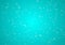 Snow particles on bright turquoise background