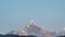 Snow Peak of Machapuchare Mountain also called Fishtail Mountain at Sunrise in the Himalayas in Nepal. Timelapse