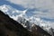 Snow peak between the sky and the dark slope, the Alps