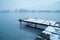 Snow on a pier on a frozen lake