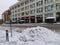 Snow pile in front of a building faced with terracotta