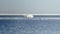 Snow pile, hill. Large snow drift  on a blue sky background,  outdoor view of ice blocks at frozen finland lake in winter